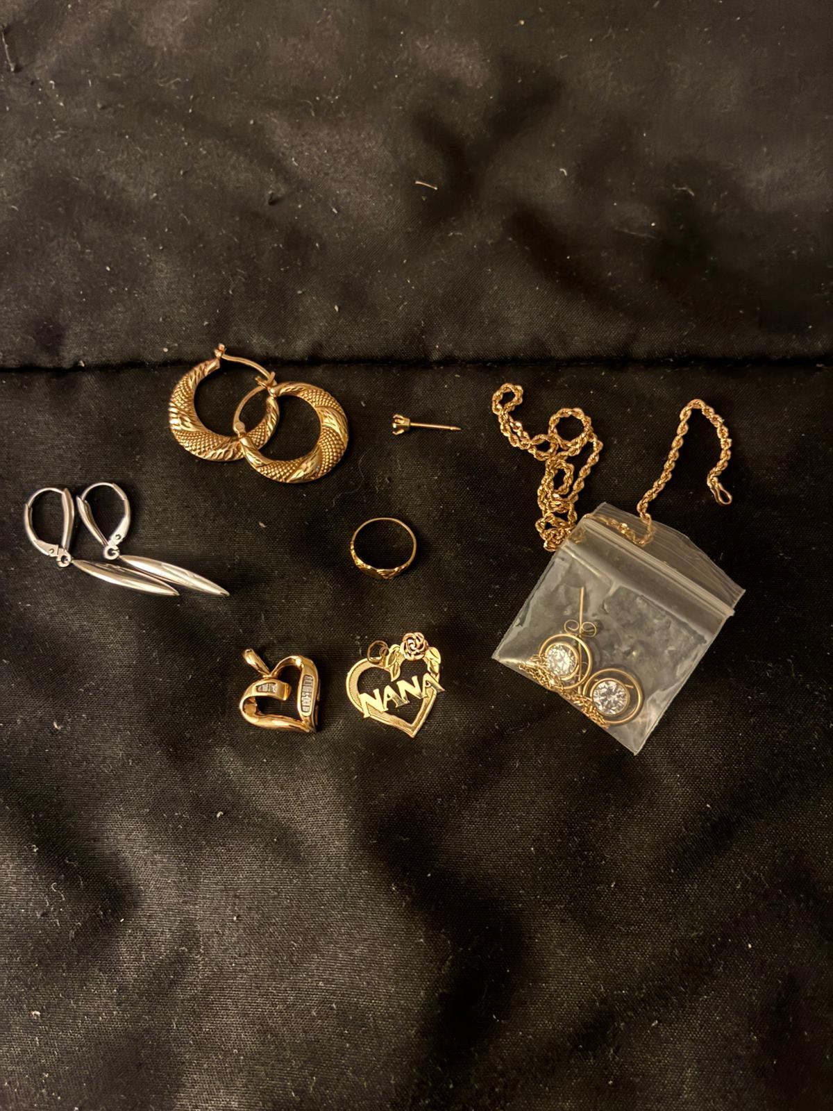 Collection of gold hoops, pendants, and stud earrings