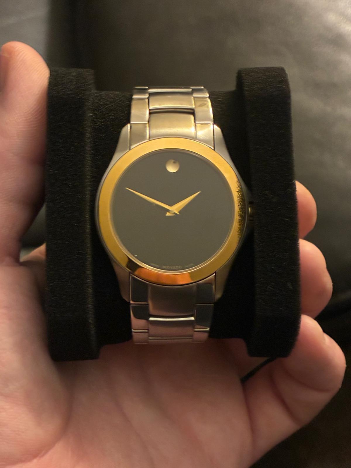 Two-tone Movado Museum watch on a velvet pillow
