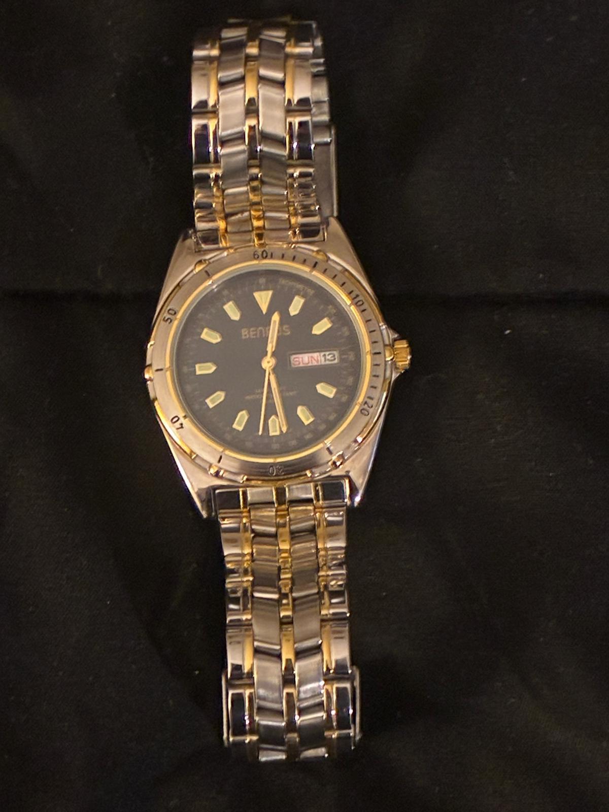 Two-tone Benrus day-date watch on black cloth