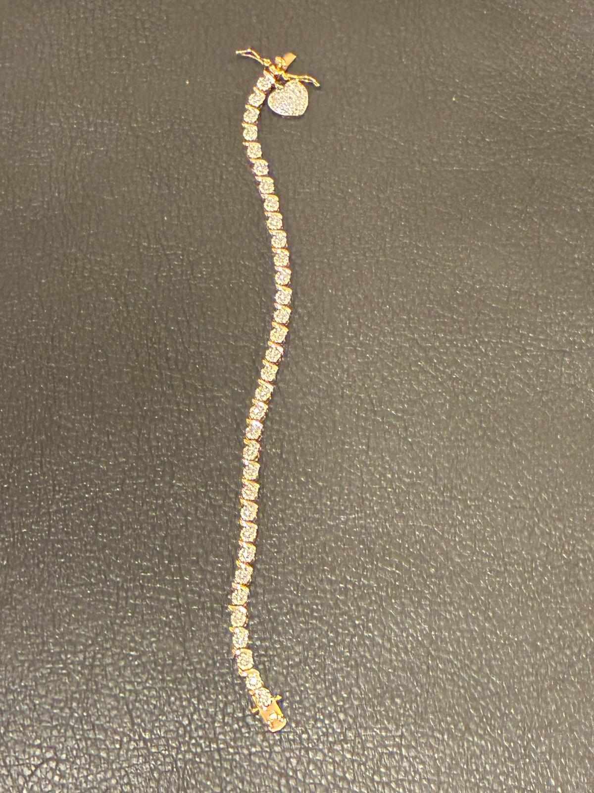 Gold tennis bracelet with heart charm